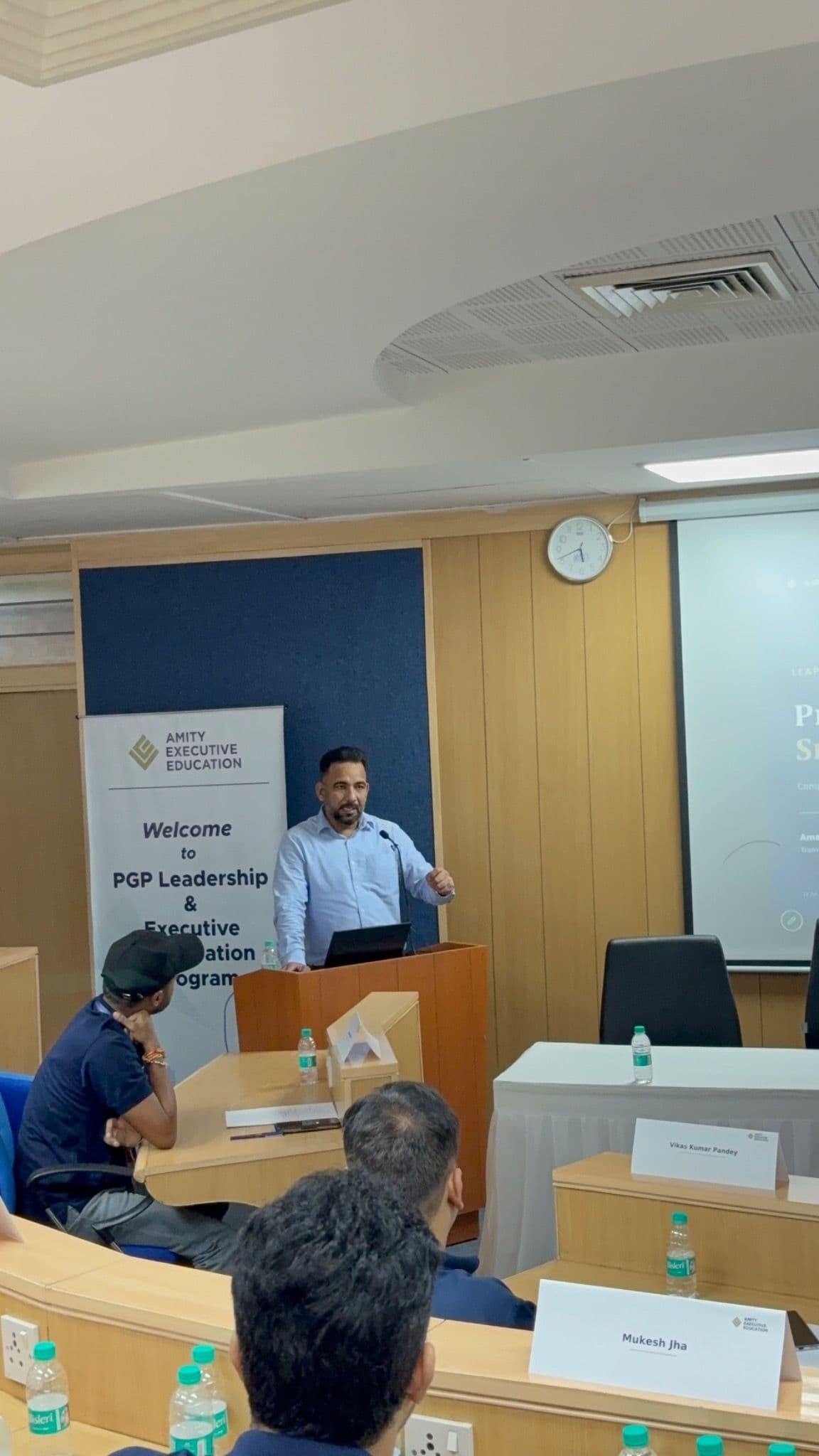 A speaker addressing participants during an AEE classroom session.